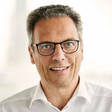 a man wearing glasses and a white shirt